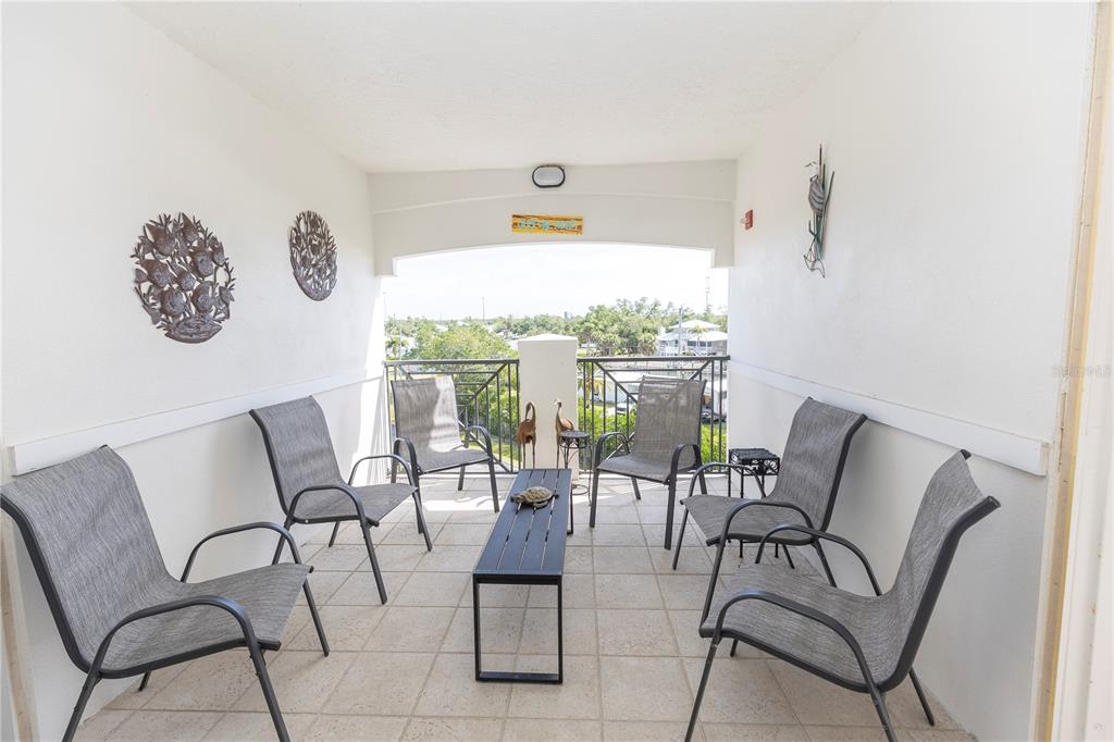 9203 Griggs Road, Unit D302 Englewood, FL 34224 - Photo 51 of 73 a view of a livingroom with furniture and outdoor seating