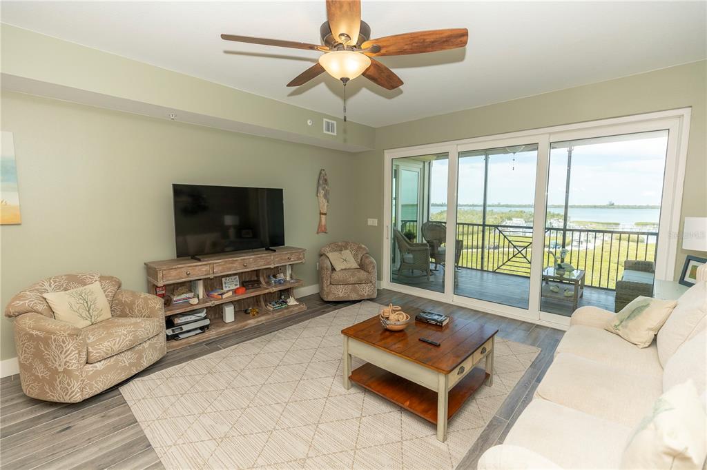 9203 Griggs Road, Unit D302 Englewood, FL 34224 - Photo 7 of 73 a living room with furniture and a flat screen tv