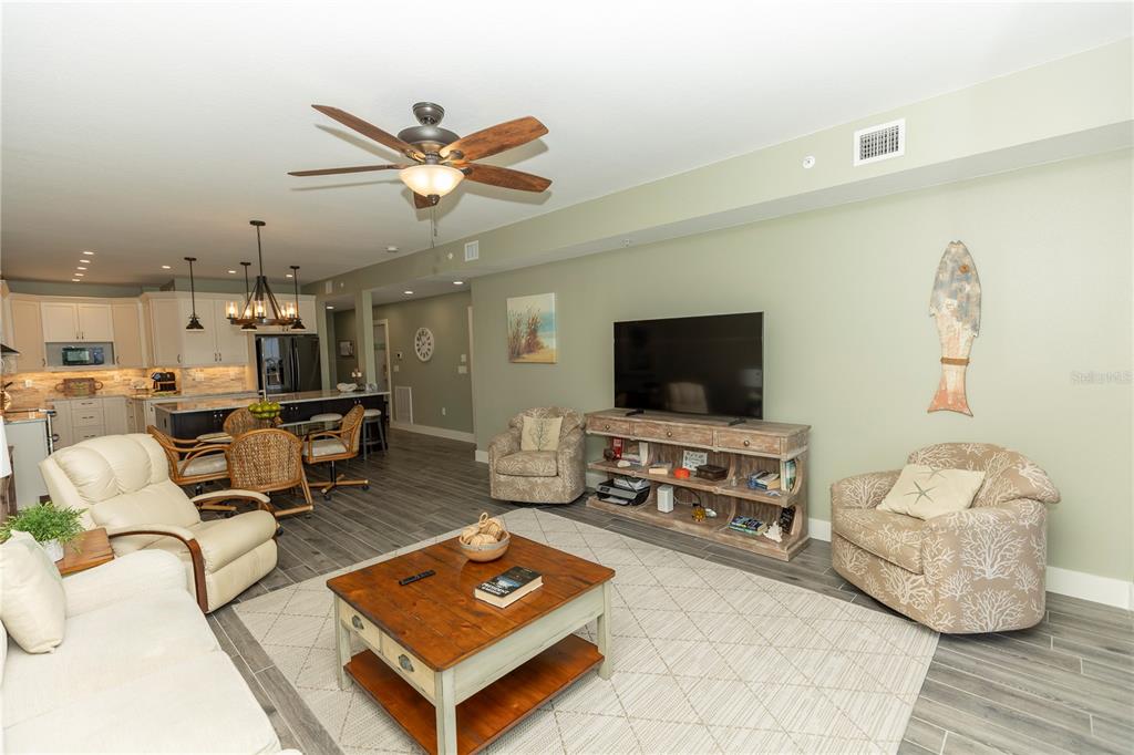 9203 Griggs Road, Unit D302 Englewood, FL 34224 - Photo 8 of 73 a living room with furniture and a flat screen tv