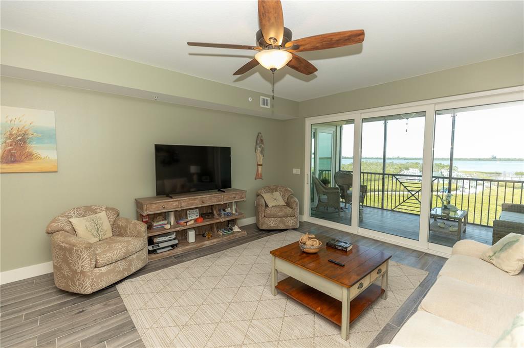 9203 Griggs Road, Unit D302 Englewood, FL 34224 - Photo 10 of 73 a living room with furniture and a flat screen tv
