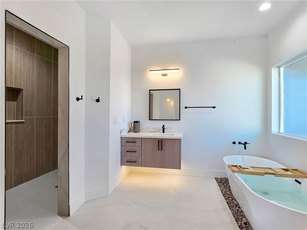 1120 West Gamebird Road Pahrump, NV 89048 - Photo 30 of 36 Full bathroom featuring a soaking tub, vanity, a walk in shower, light marble finish flooring, and recessed lighting