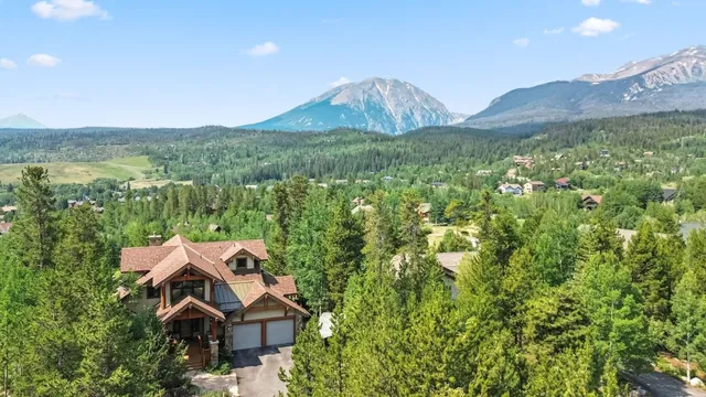 a view of a house with a yard and mountain