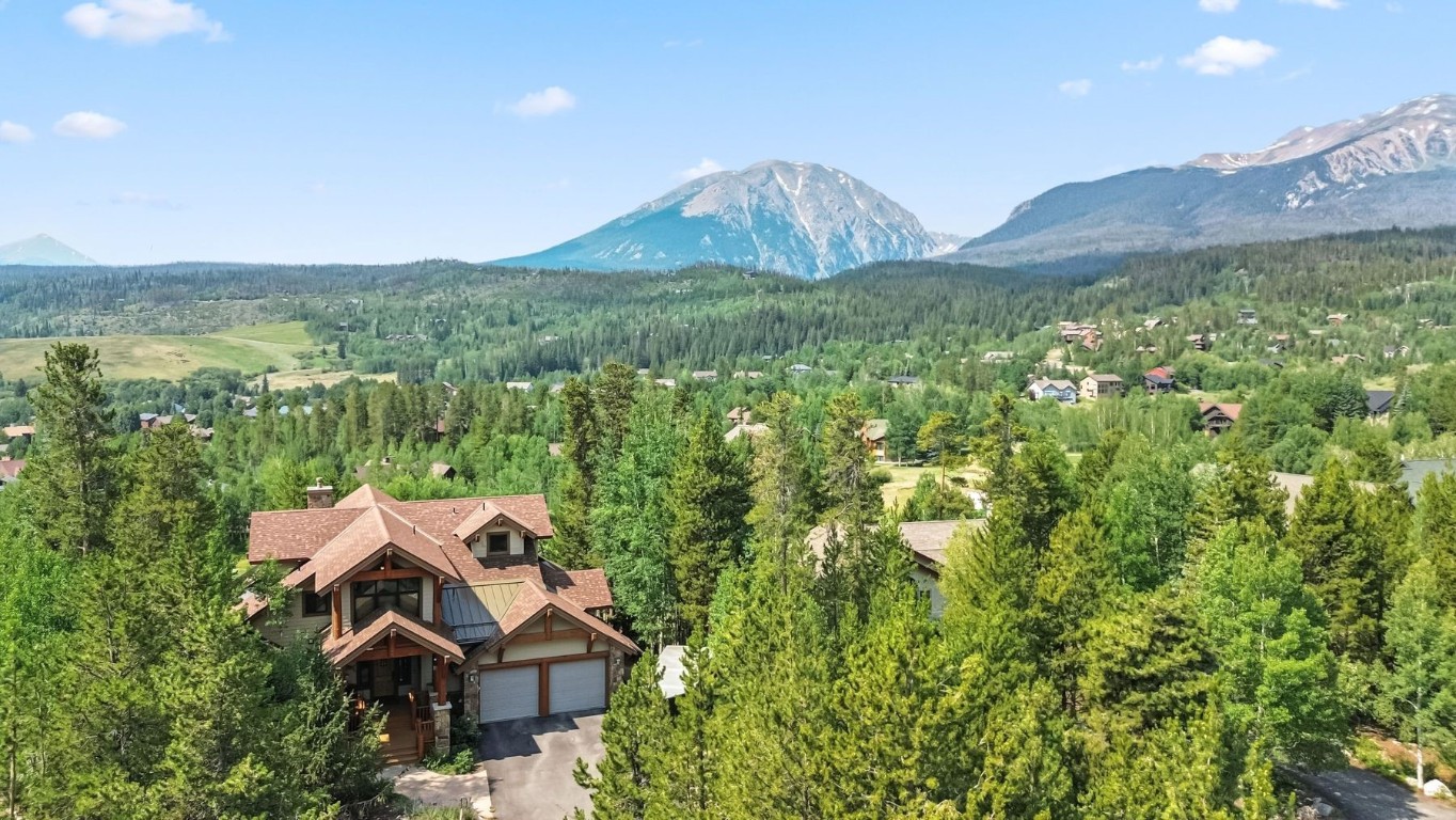 a view of a house with a yard and mountain