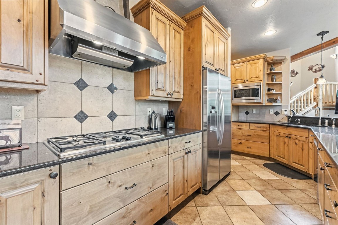 1730 Red Hawk Road Silverthorne, CO 80498 - Photo 17 of 50 a kitchen with stainless steel appliances granite countertop a stove and a sink