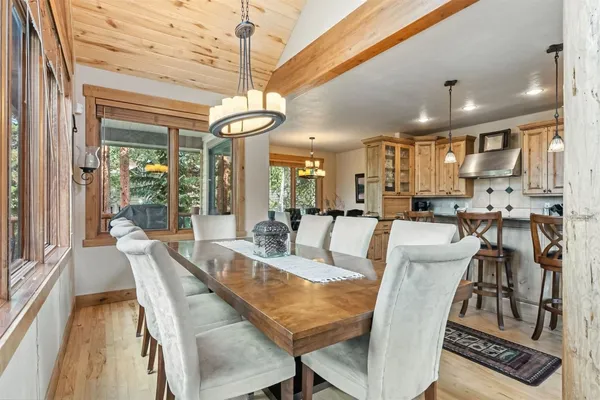 a view of a dining room with furniture wooden floor and chandelier