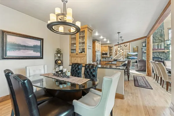 a dining room with furniture a rug and wooden floor