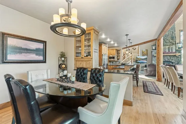 a dining room with furniture a rug and wooden floor