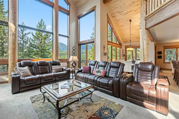 a living room with furniture a rug and a large window
