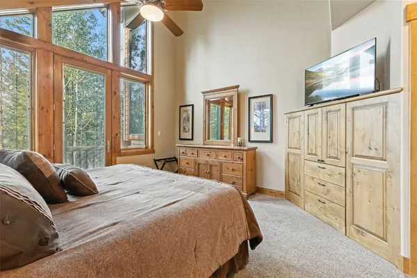 a bedroom with a large bed and a window