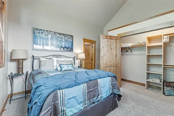 a bedroom with a bed and a lamp on table