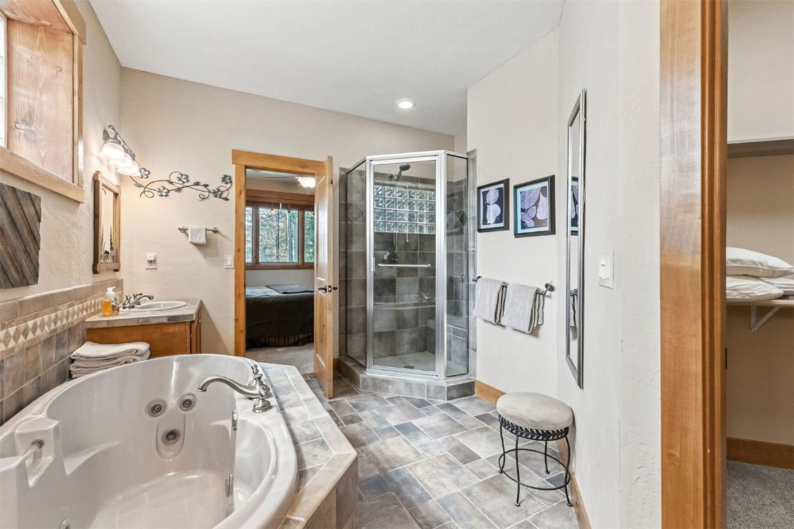 1730 Red Hawk Road Silverthorne, CO 80498 - Photo 26 of 50 a spacious bathroom with a tub sink and mirror