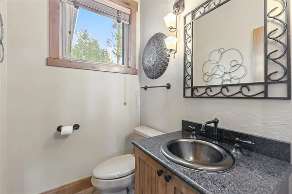 a bathroom with a toilet sink and mirror