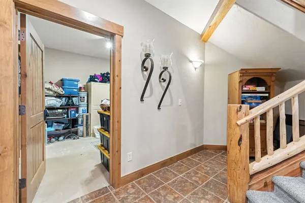 a view of a hallway to room with wooden floor and stairs