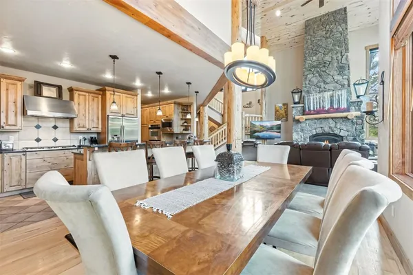 a living room with fireplace furniture and a large window
