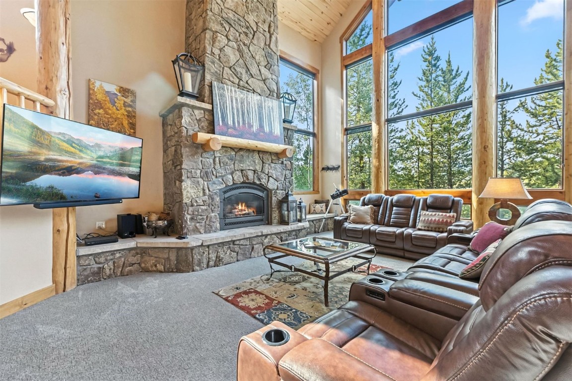 1730 Red Hawk Road Silverthorne, CO 80498 - Photo 44 of 50 a living room with furniture a fireplace and a floor to ceiling window