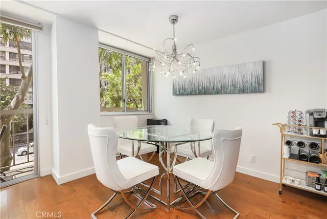 a view of a dining room with furniture window and wooden floor