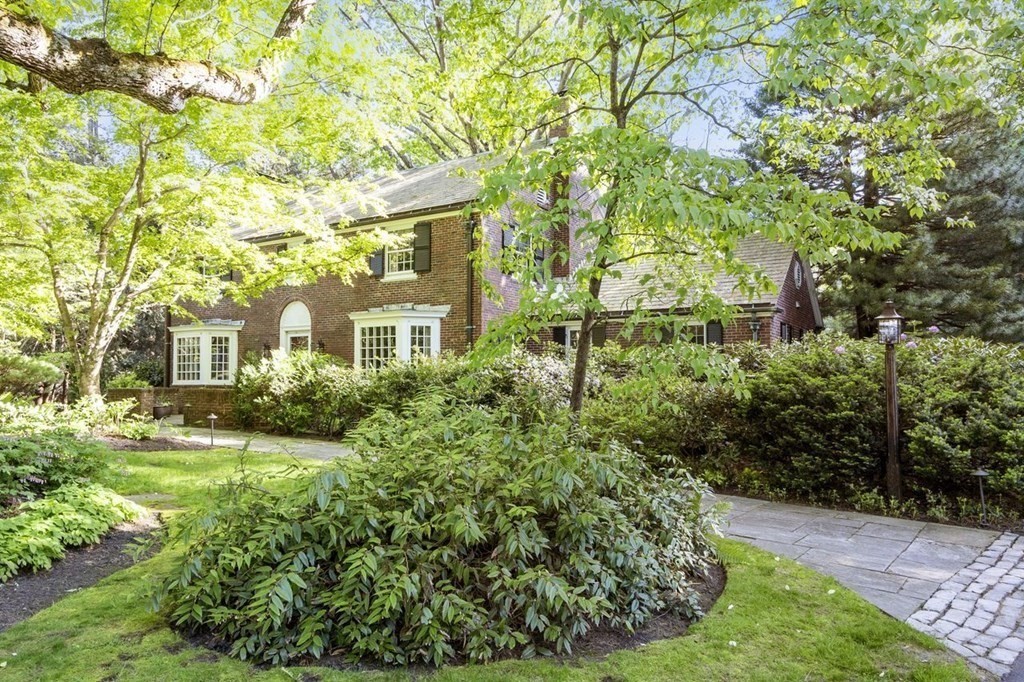 9 Aylesbury Road Worcester, MA 01609 - Photo 2 of 40 a view of a brick house with a big yard plants and large trees