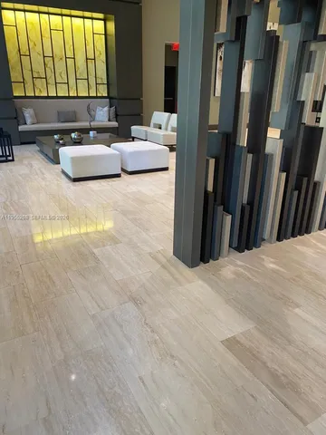 a living room with furniture and large windows