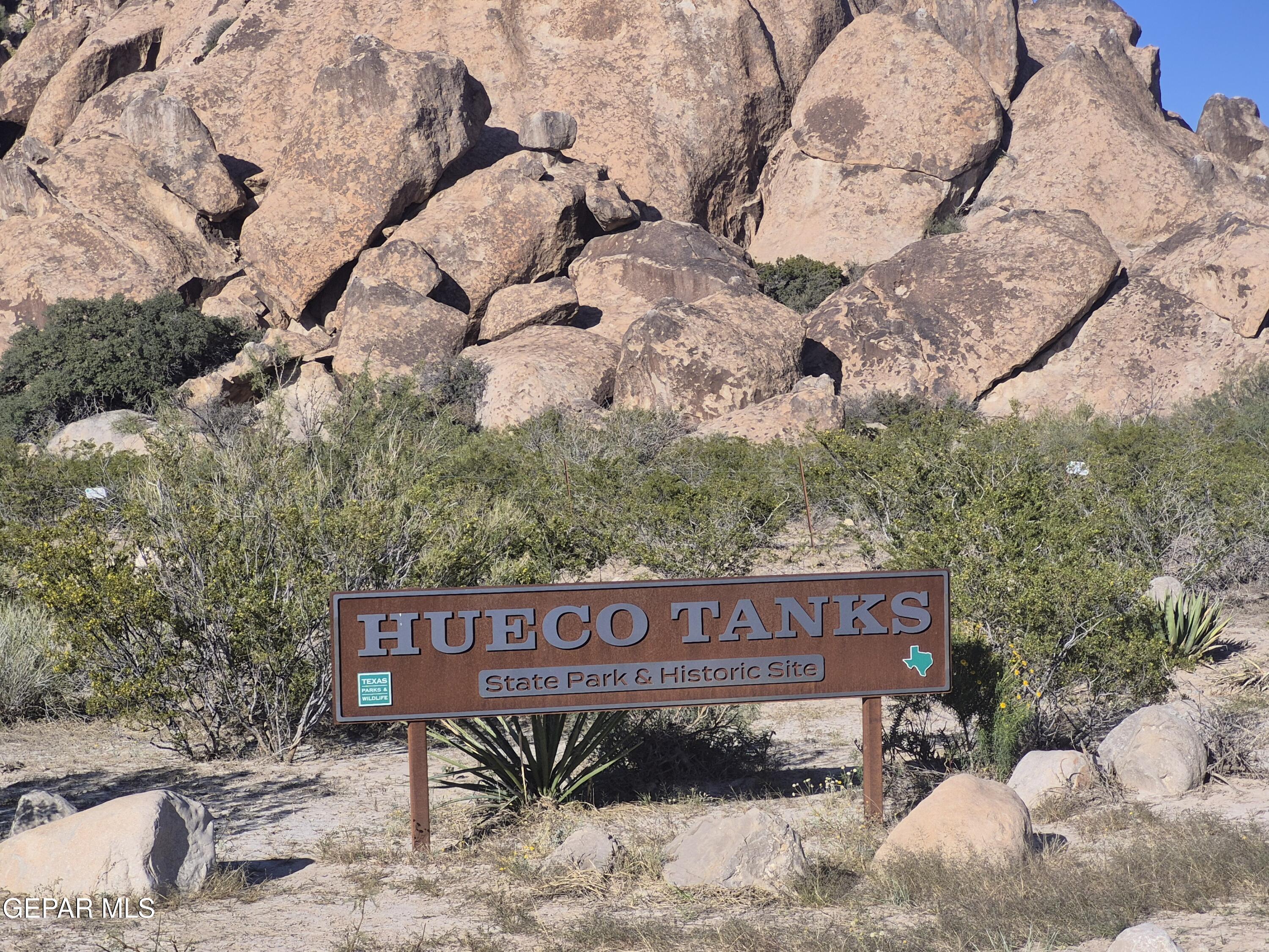 6801 Hueco Tanks Road El Paso, TX 79938 - Photo 6 of 6 a view of a sign board with large trees