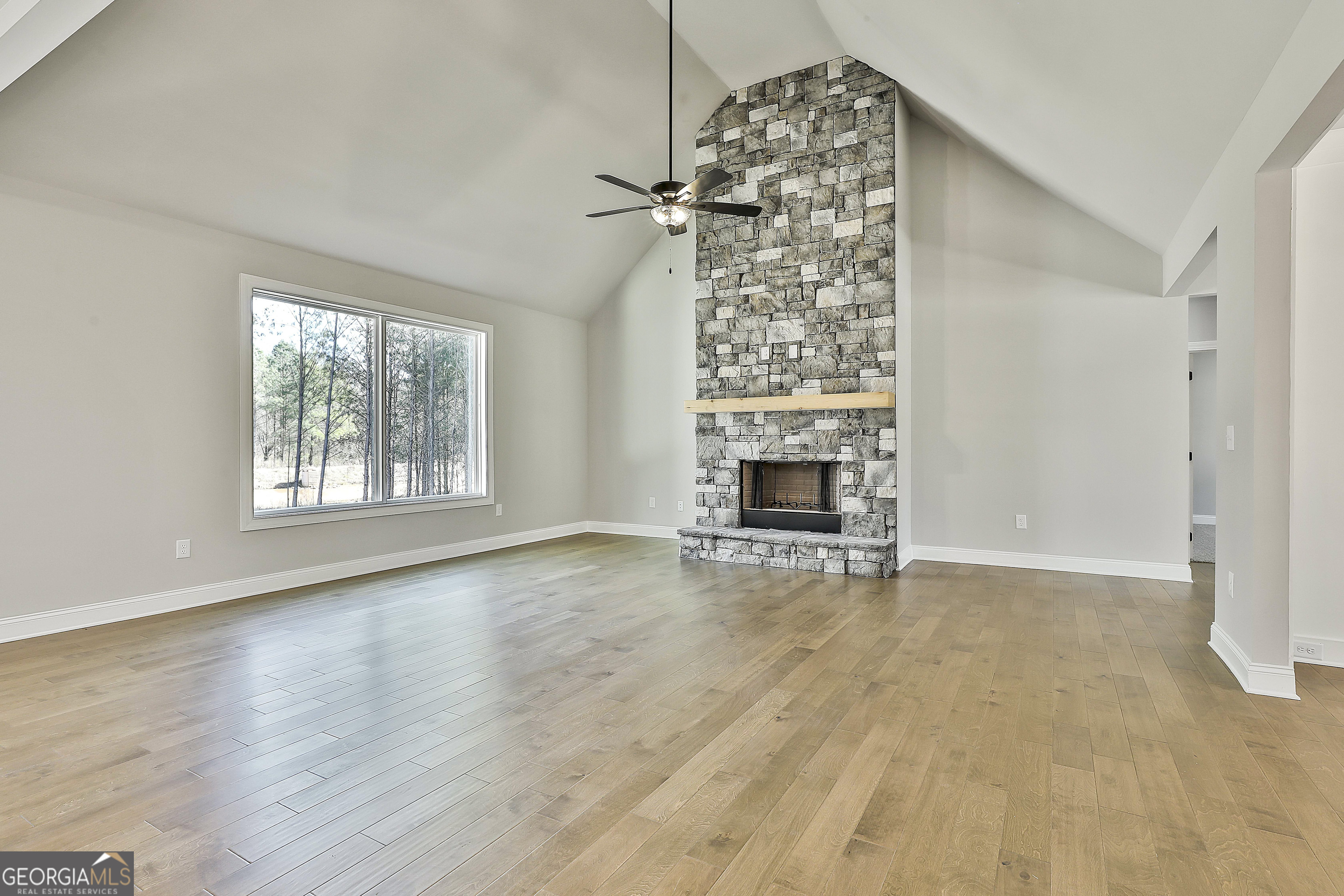 837 Alex Stephens Road Moreland, GA 30259 - Photo 14 of 50 an empty room with windows and fireplace