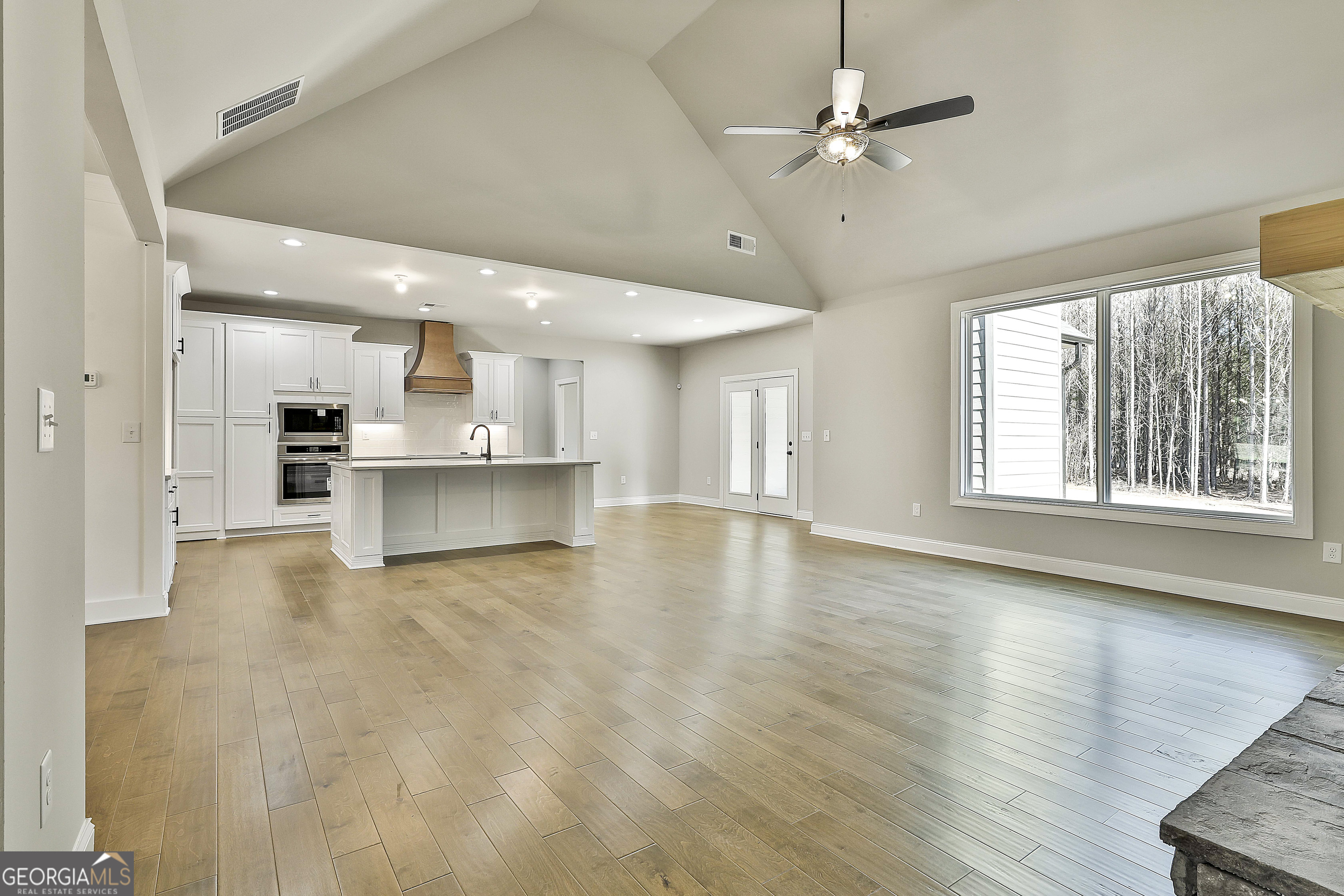 837 Alex Stephens Road Moreland, GA 30259 - Photo 18 of 50 a view of an empty room with a window and kitchen view