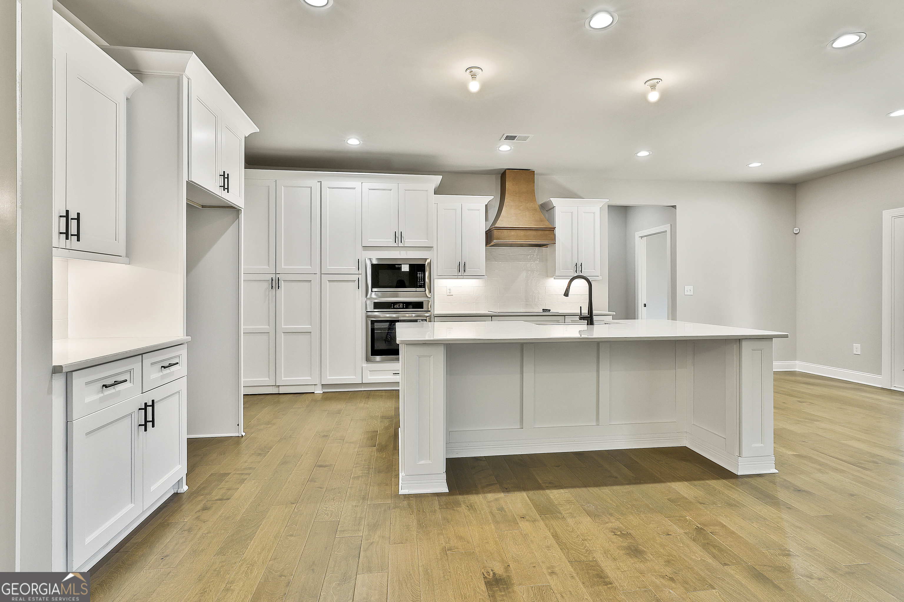 837 Alex Stephens Road Moreland, GA 30259 - Photo 19 of 50 a kitchen with stainless steel appliances a refrigerator stove microwave and cabinets