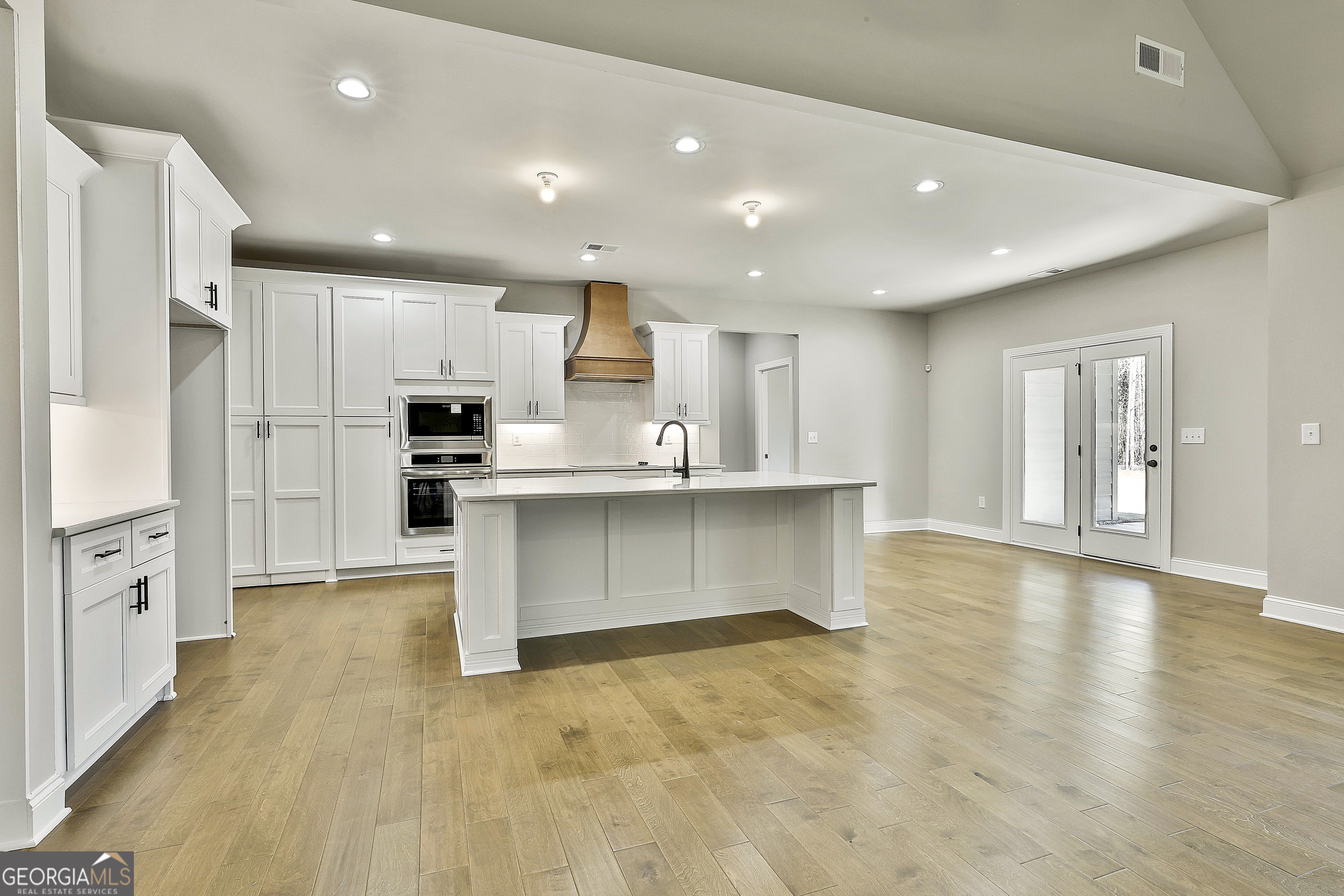 837 Alex Stephens Road Moreland, GA 30259 - Photo 20 of 50 a large kitchen with stainless steel appliances a large counter top and a stove top oven