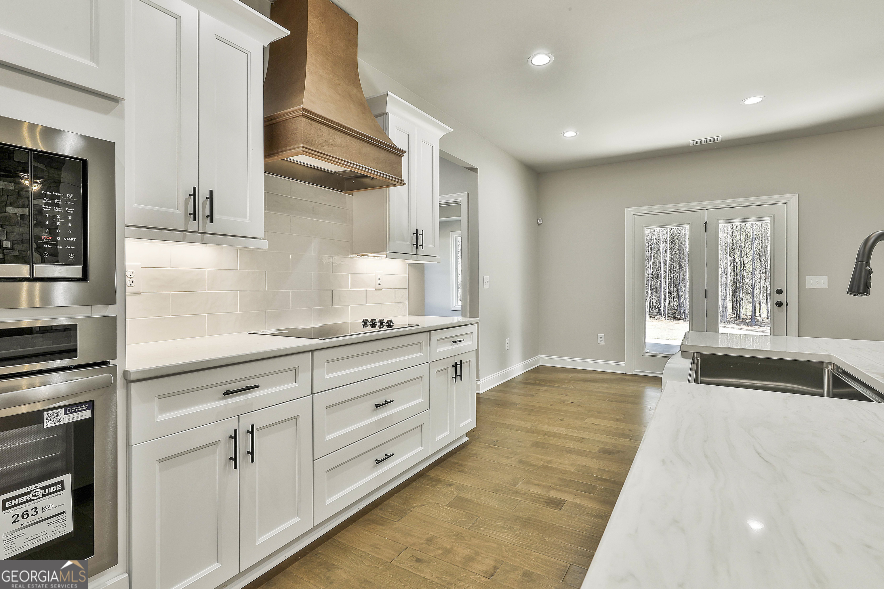 837 Alex Stephens Road Moreland, GA 30259 - Photo 24 of 50 a kitchen with granite countertop white cabinets and stainless steel appliances