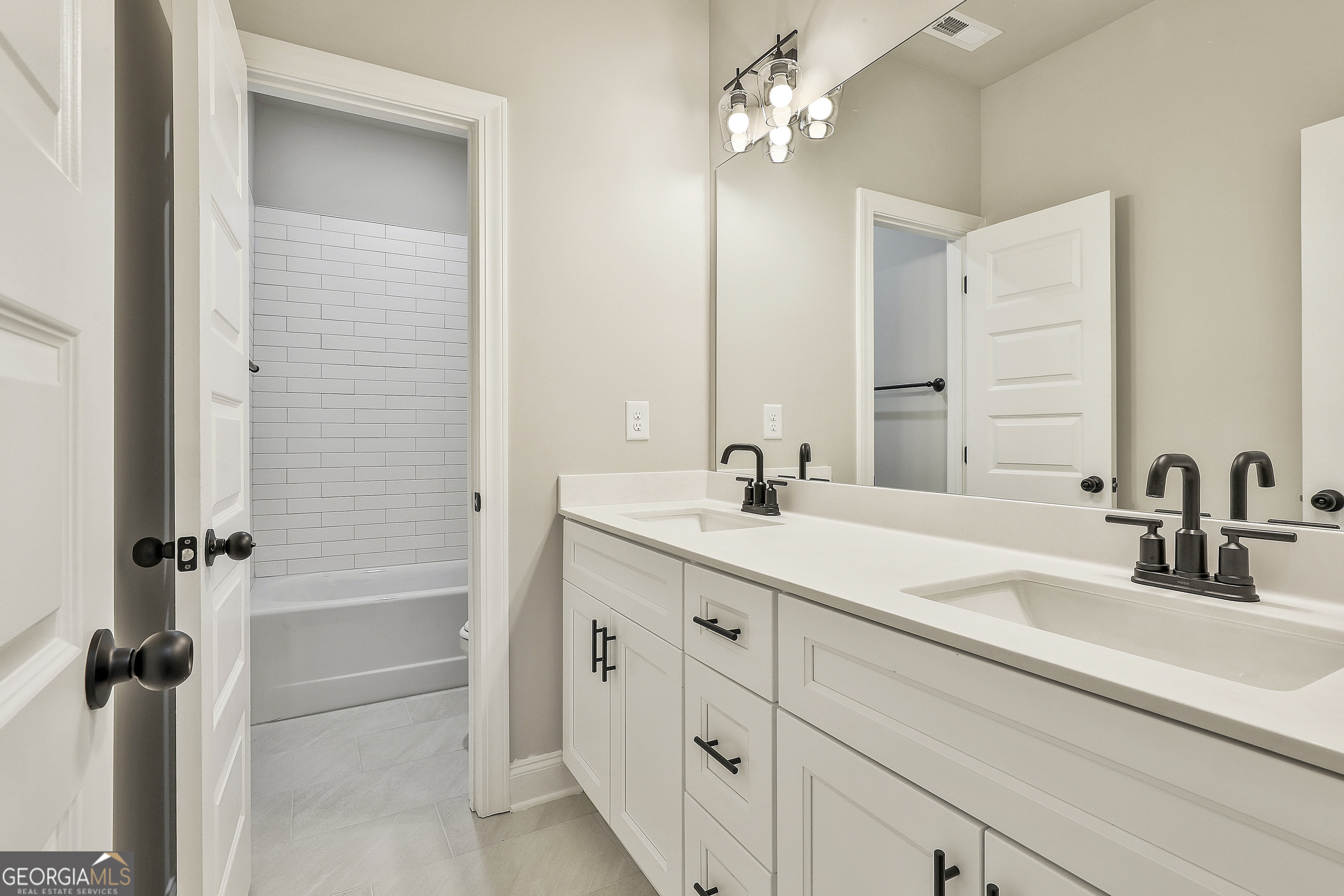 837 Alex Stephens Road Moreland, GA 30259 - Photo 32 of 50 a bathroom with a double vanity sink a mirror and a shower