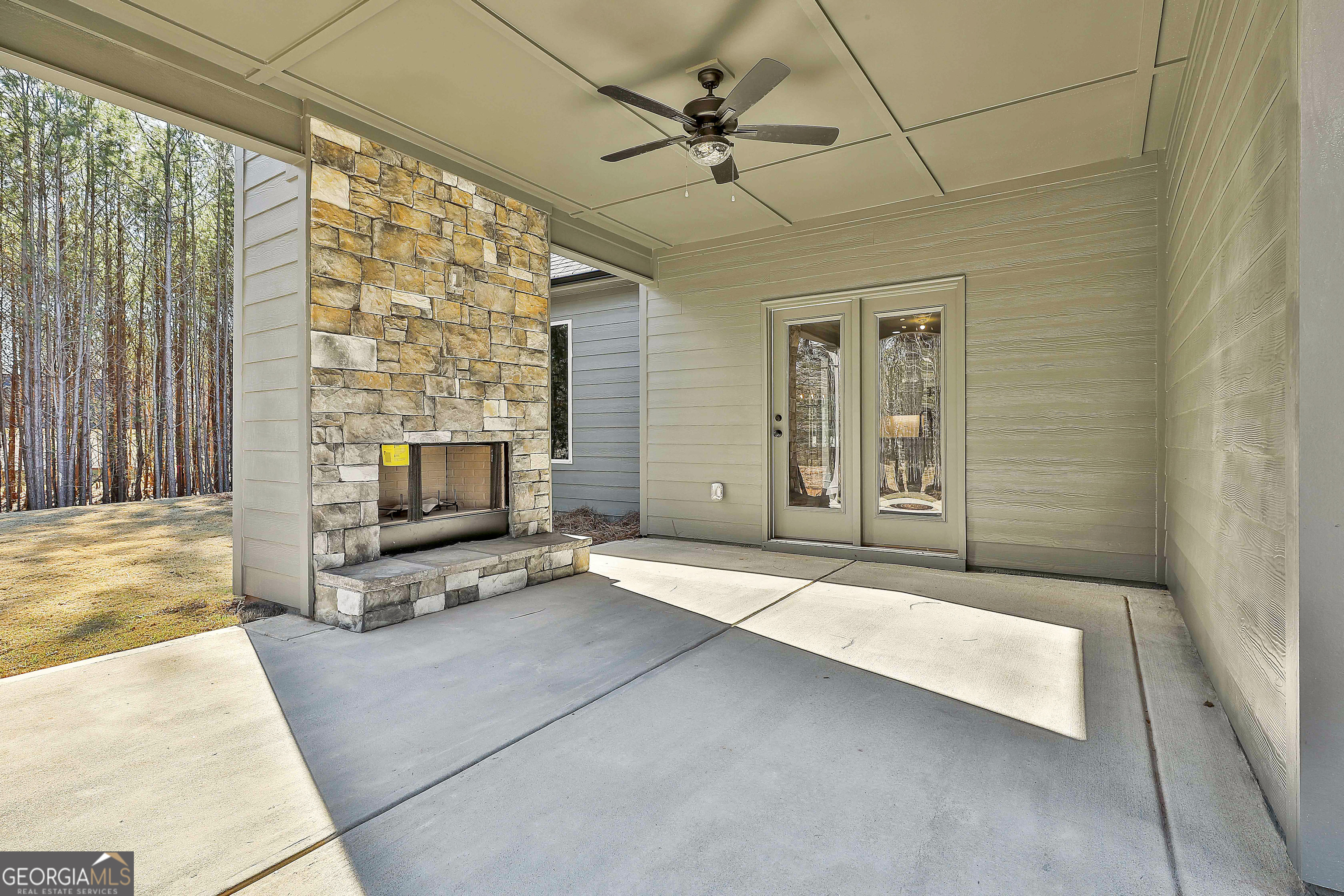 837 Alex Stephens Road Moreland, GA 30259 - Photo 46 of 50 a living room with patio furniture and a fireplace