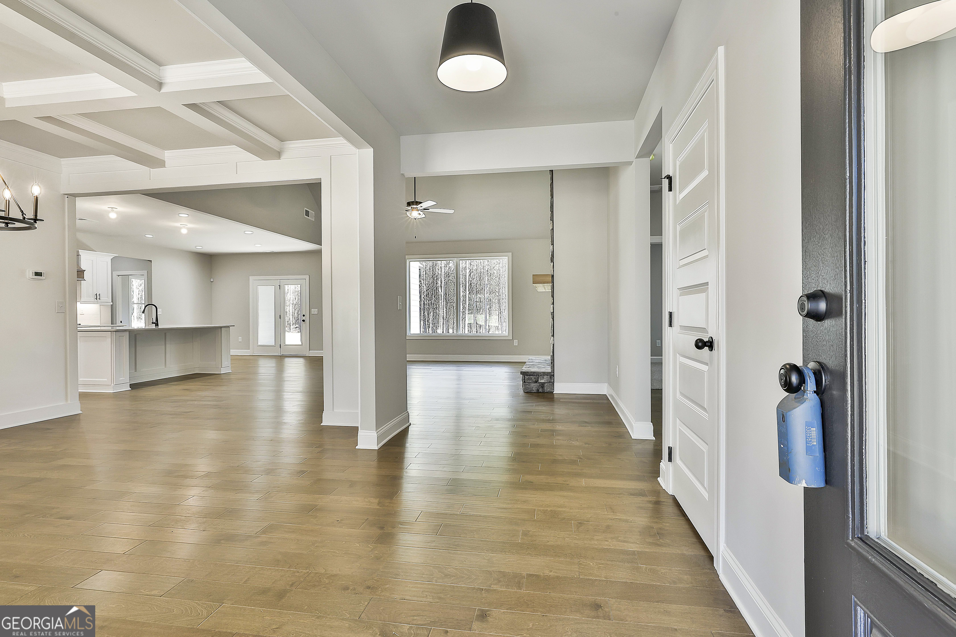 837 Alex Stephens Road Moreland, GA 30259 - Photo 9 of 50 a view of a hallway with wooden floor and a kitchen