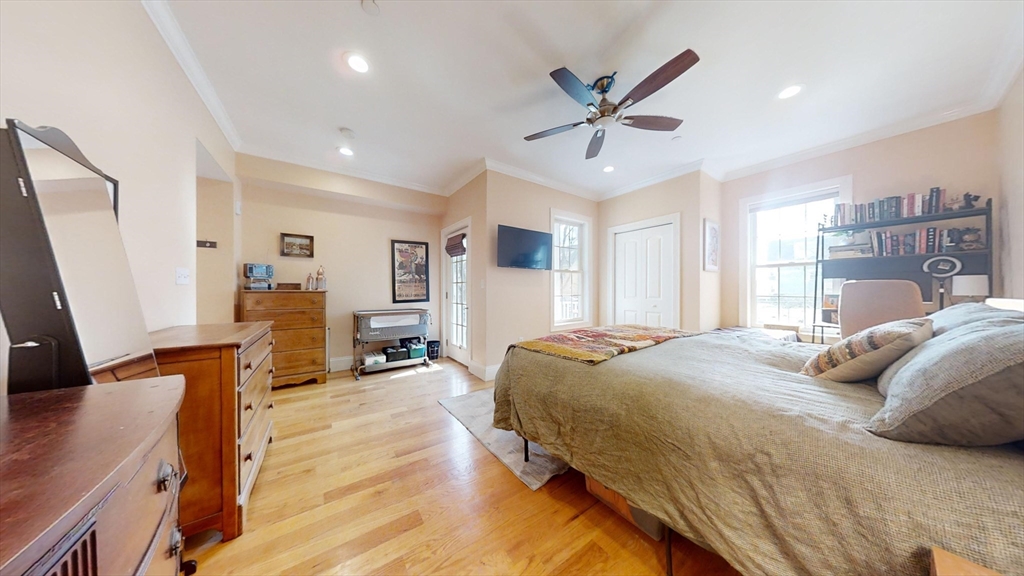 42 Olney Street, Unit 1R Boston, MA 02121 - Photo 16 of 21 a bedroom with a bed and wooden floor