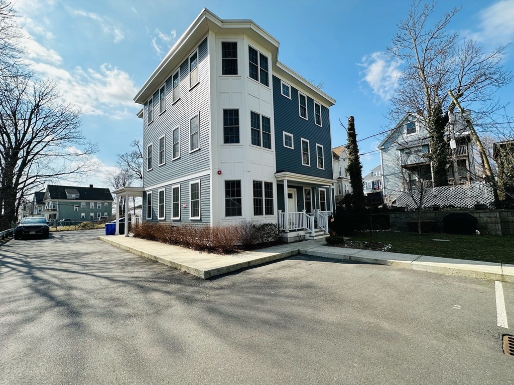 42 Olney Street, Unit 1R Boston, MA 02121 - Photo 19 of 21 a front view of a building with a yard