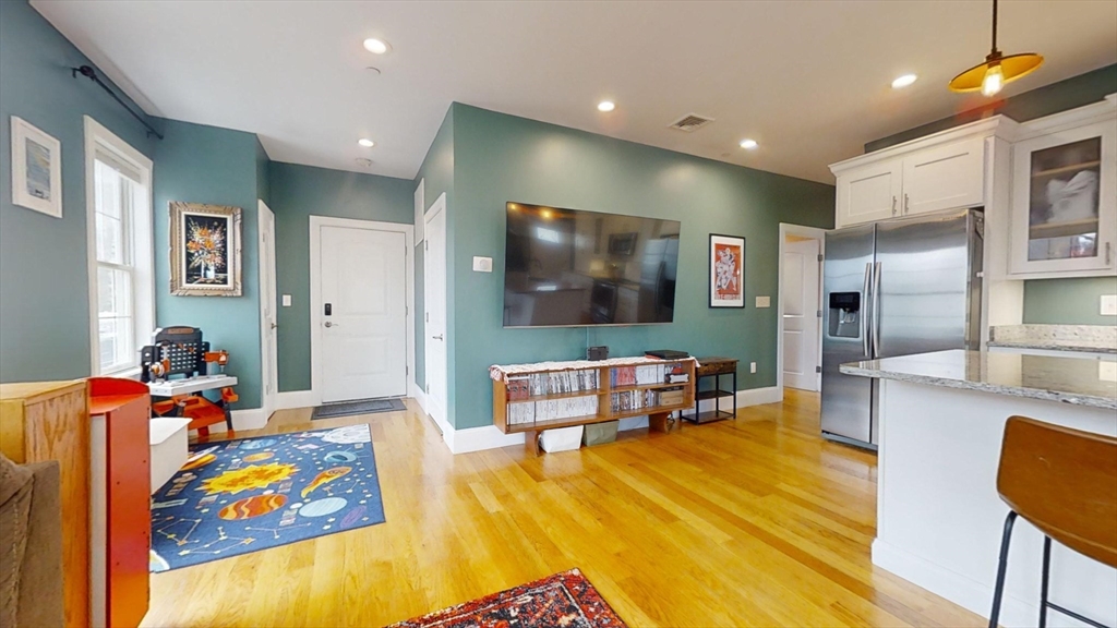 42 Olney Street, Unit 1R Boston, MA 02121 - Photo 7 of 21 a living room with furniture and a flat screen tv