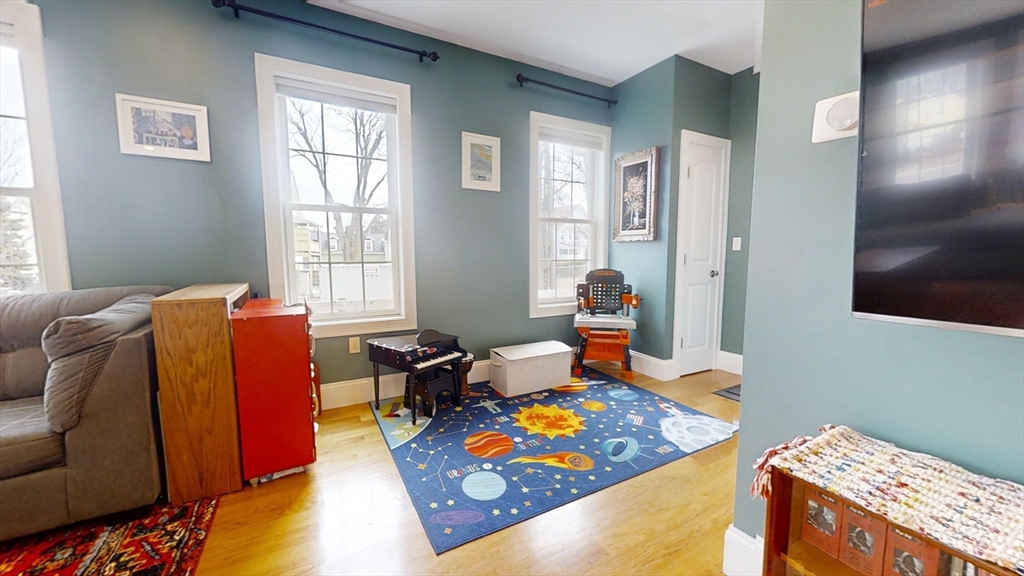 42 Olney Street, Unit 1R Boston, MA 02121 - Photo 8 of 21 a bed room with a bed and a chair