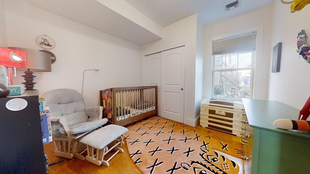42 Olney Street, Unit 1R Boston, MA 02121 - Photo 10 of 21 a bedroom with furniture and wooden floor