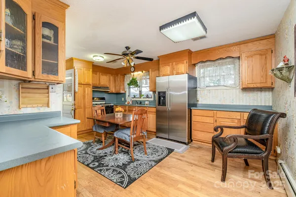 a living room with furniture a rug and kitchen view