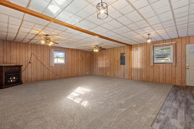 a view of a livingroom with an empty space and a window