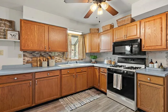 a kitchen with stainless steel appliances granite countertop a sink and cabinets