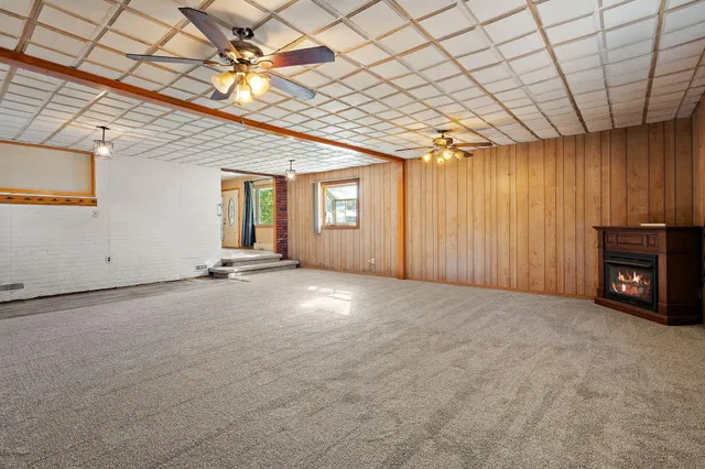 a view of an empty room with a fireplace