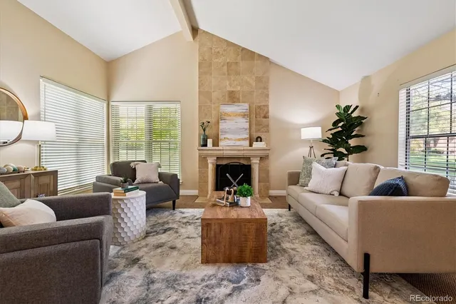 a living room with furniture and a fireplace