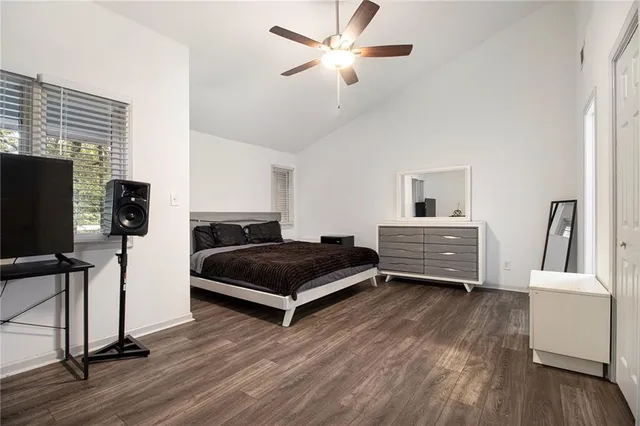 a bedroom with furniture and a flat screen tv