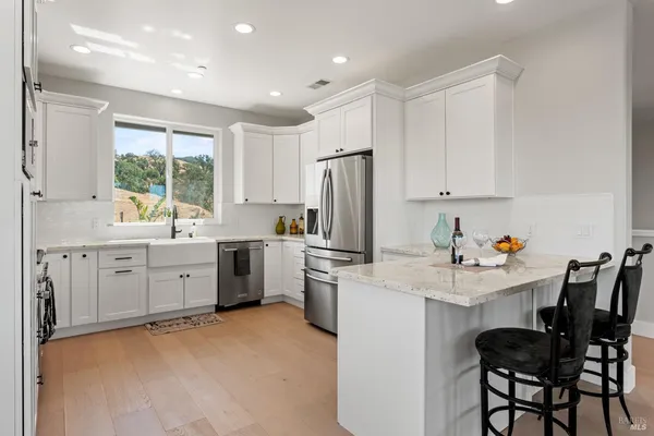 a kitchen with stainless steel appliances a refrigerator sink and cabinets
