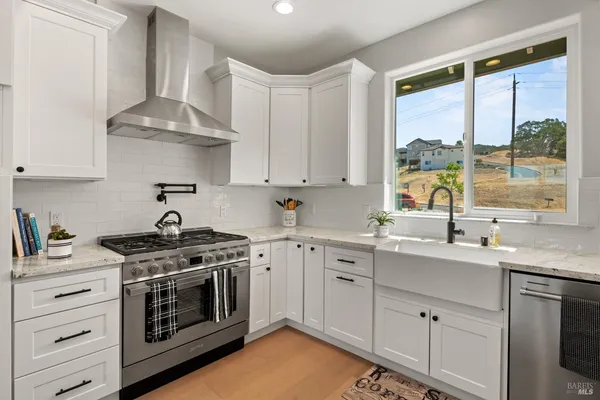 a stove top oven sitting inside of a kitchen