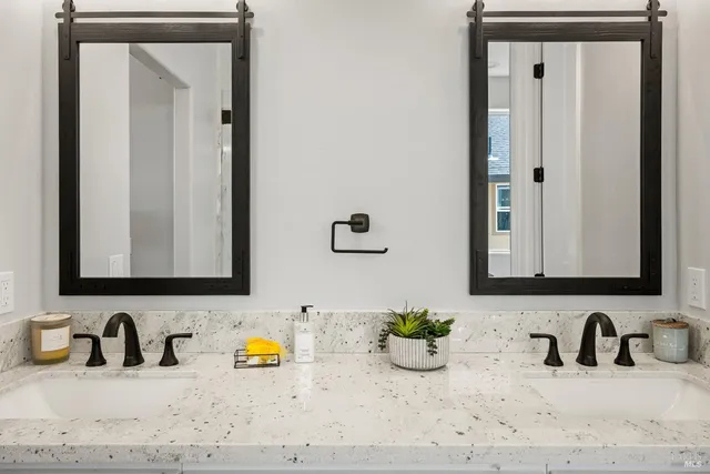 a bathroom with a sink a window and a shower