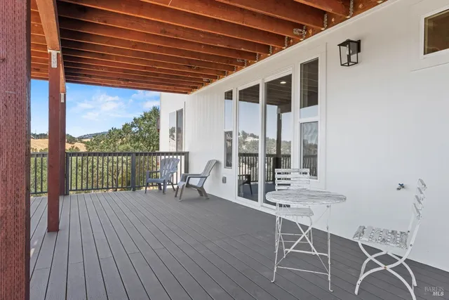 a view of a balcony with wooden floor