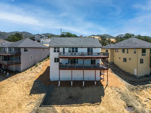 a view of a house with wooden fence