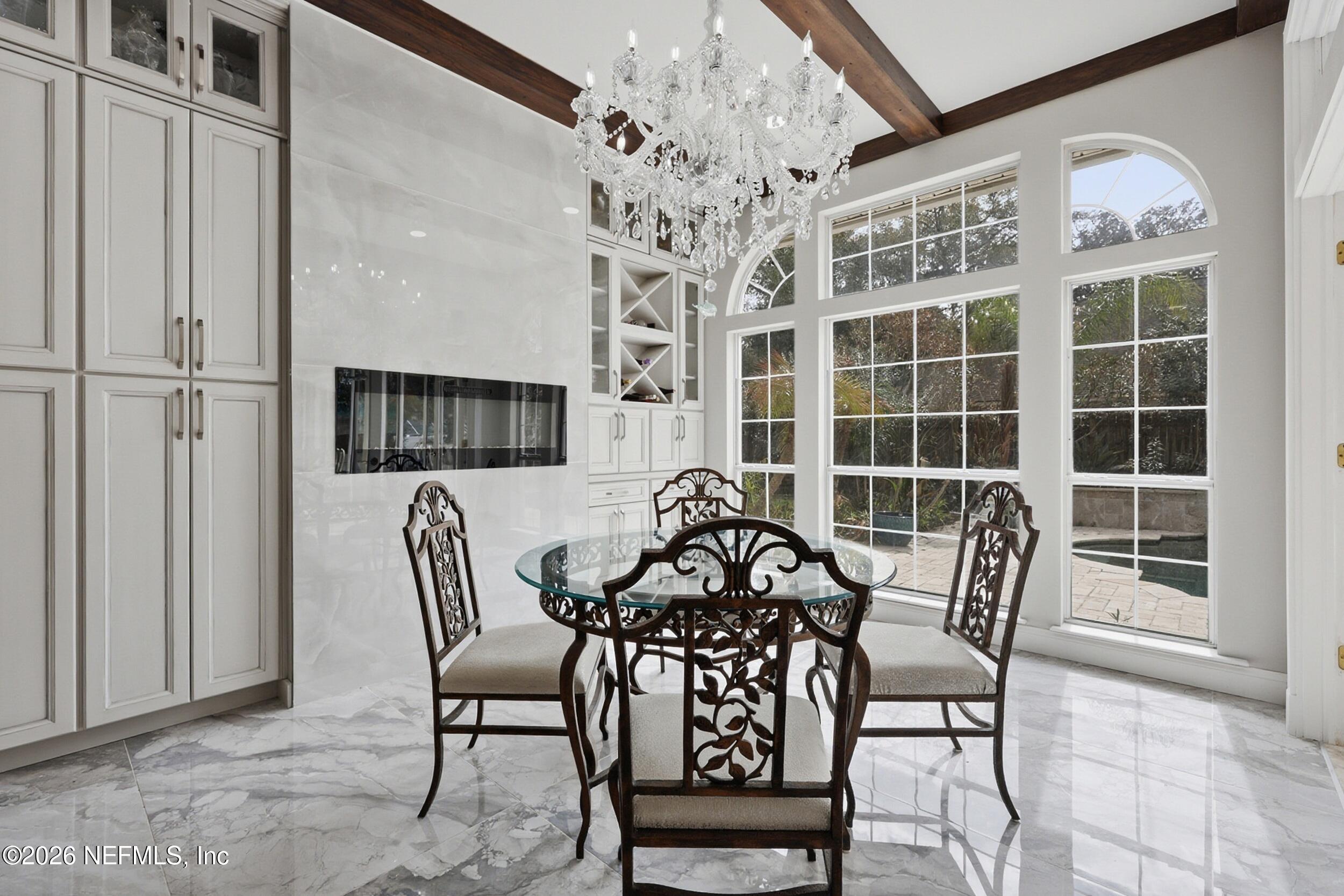40 Tallwood Road Jacksonville Beach, FL 32250 - Photo 21 of 75 a view of a dining room with furniture and chandelier