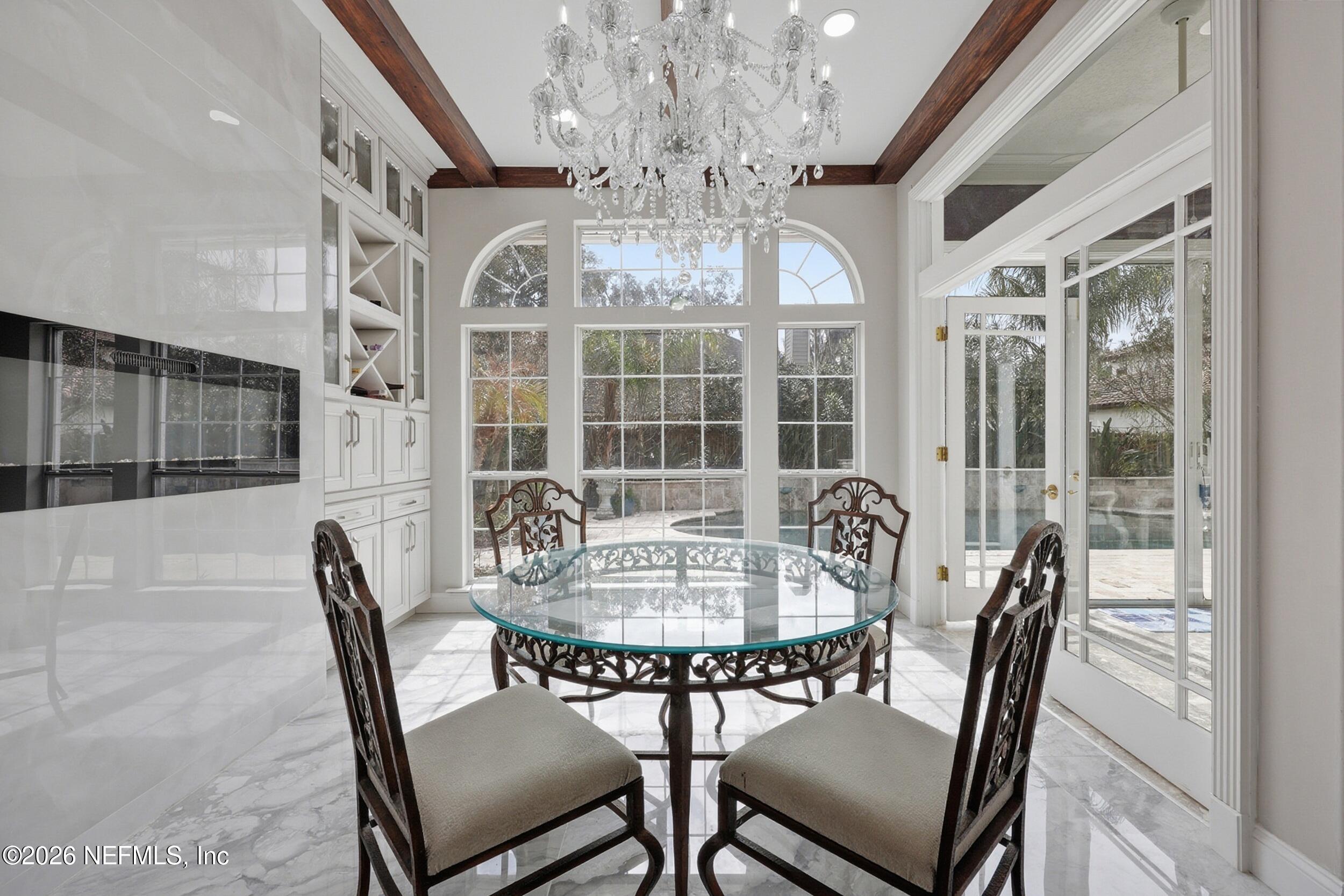 40 Tallwood Road Jacksonville Beach, FL 32250 - Photo 22 of 75 a view of a dining room with furniture wooden floor and chandelier