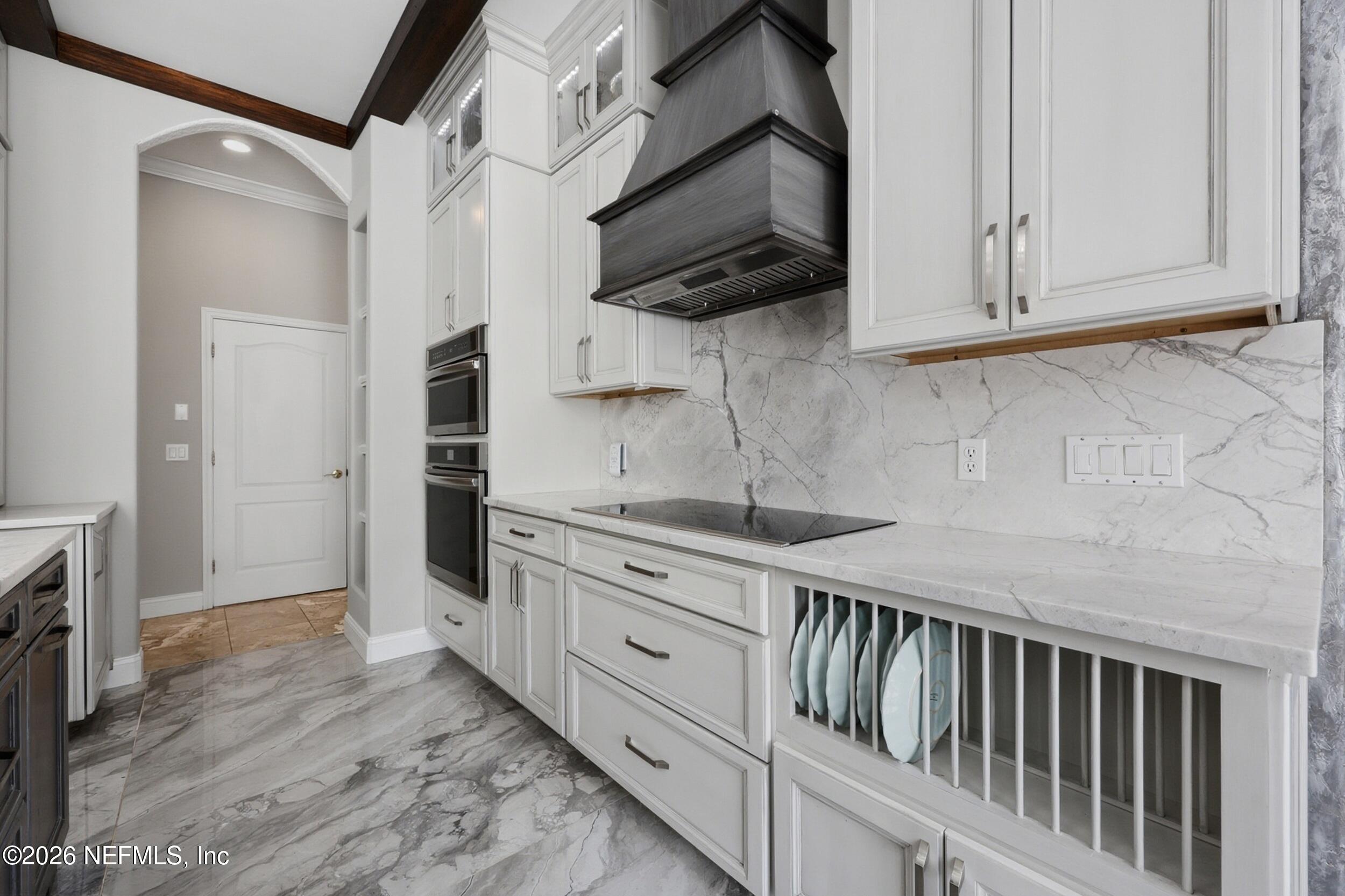 40 Tallwood Road Jacksonville Beach, FL 32250 - Photo 25 of 75 a kitchen with stainless steel appliances granite countertop a sink a stove and a microwave oven on the wooden floor